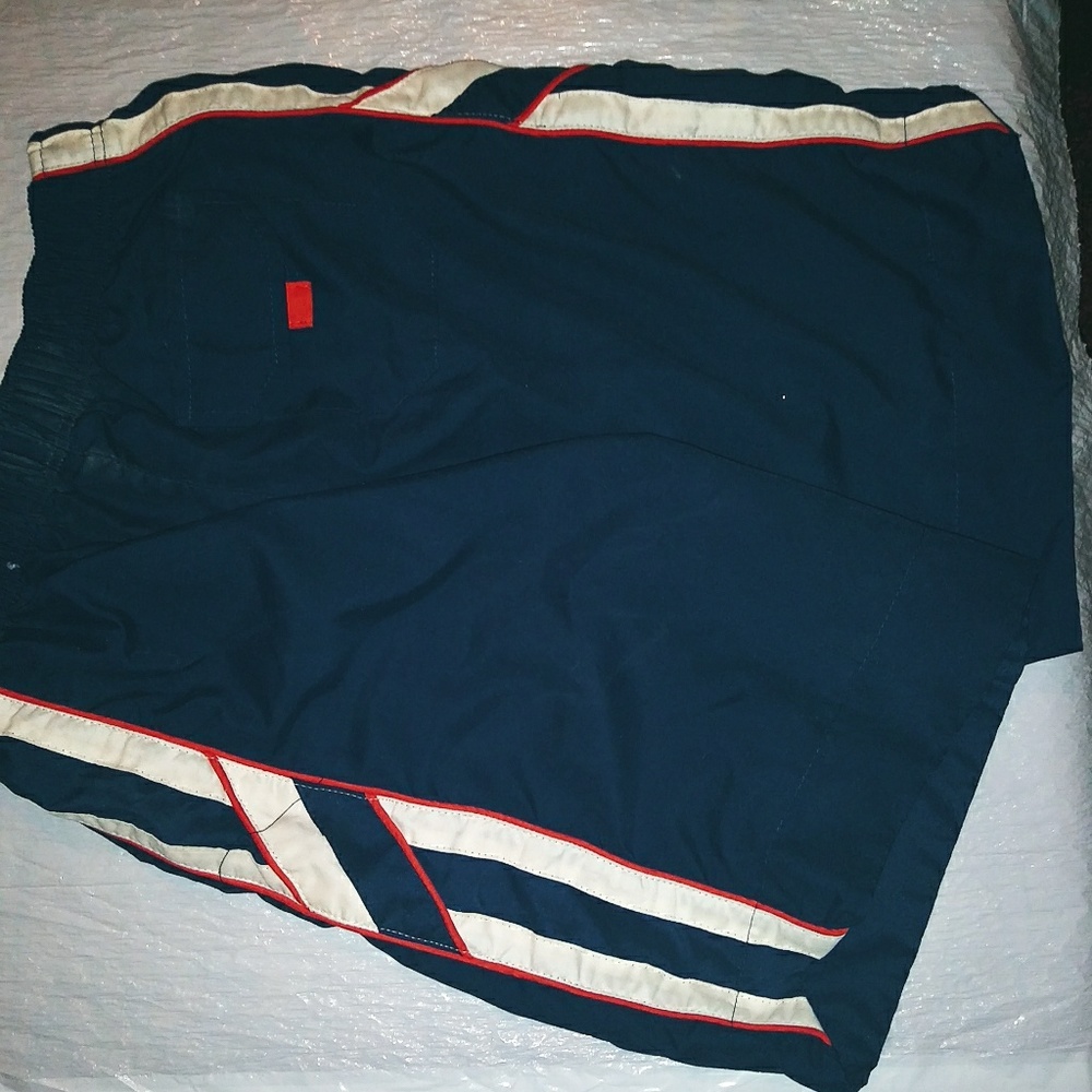 Blue swim trunks with white red strip. Netting int